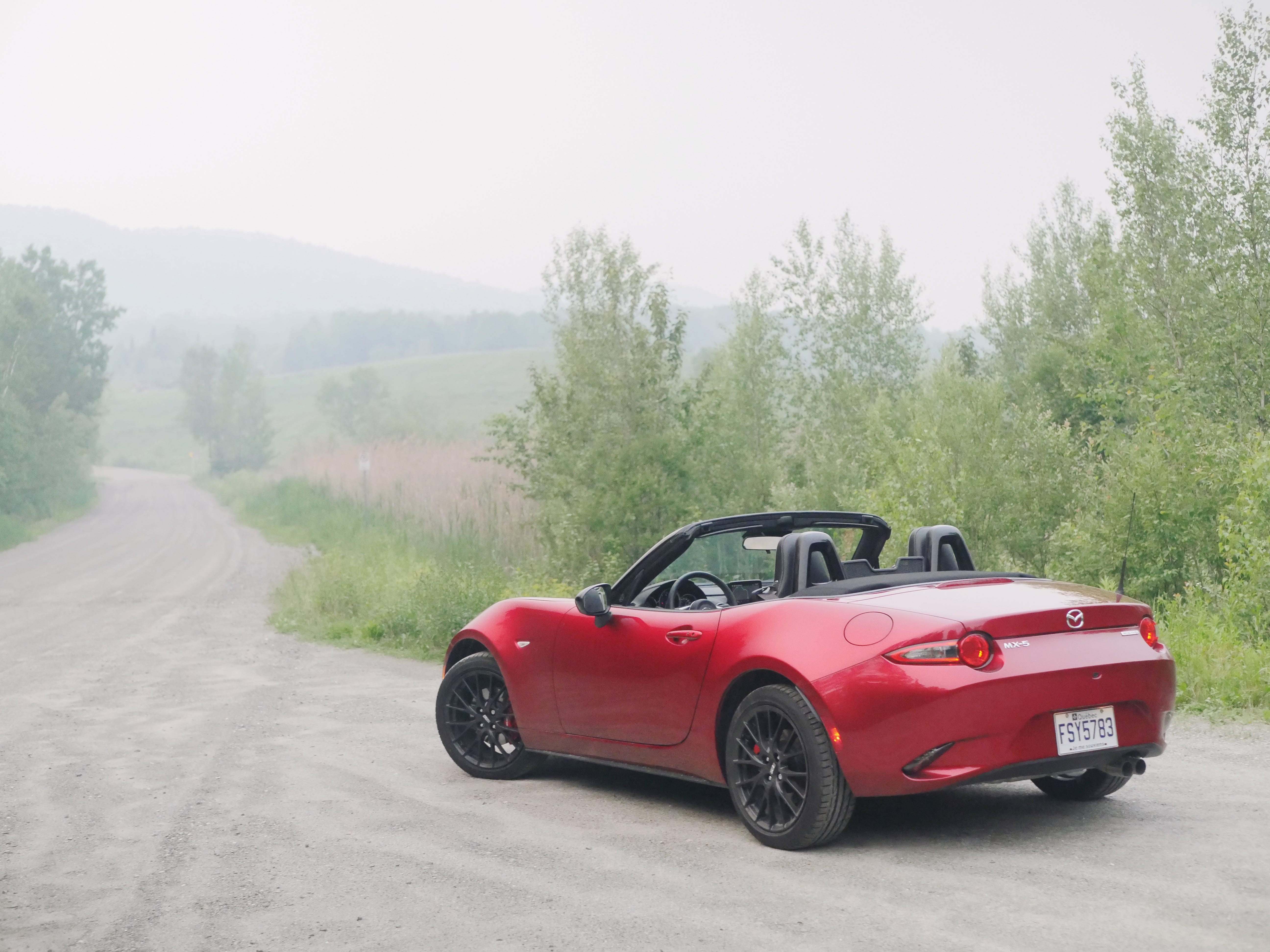 rear 3/4 of red mazda mx-5