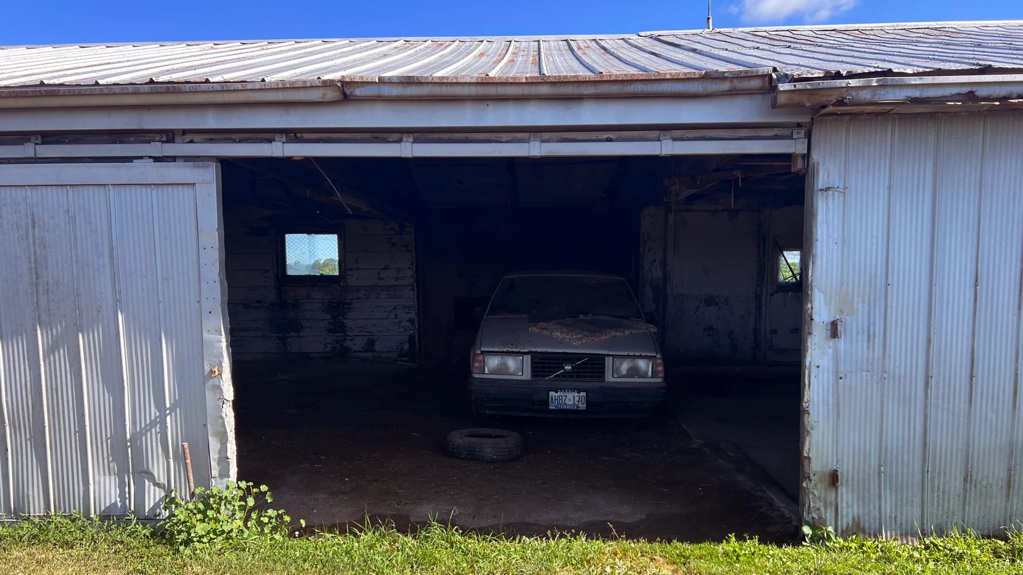 white 1990 volvo 740 turbo in a barn