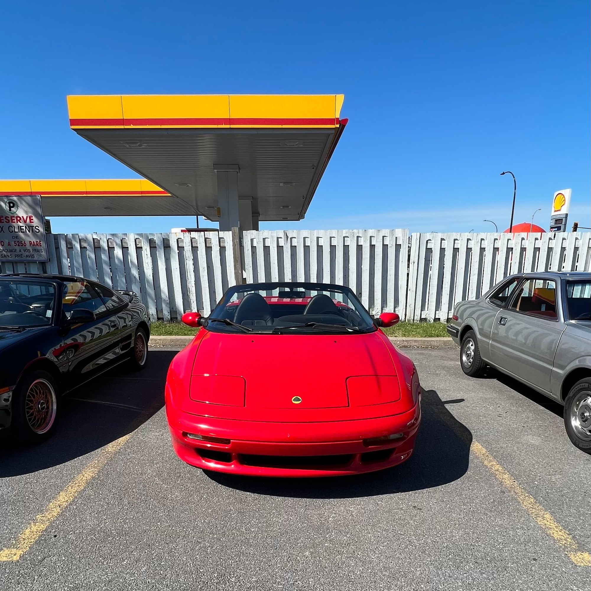 red lotus elan, 90s generation, near yellow shell gas station